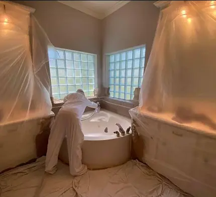 a man refinishing bathtub